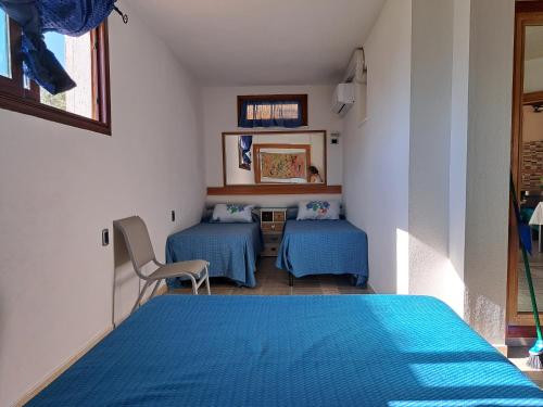 a small room with two beds and a table at casa vacanza carlo in Alghero