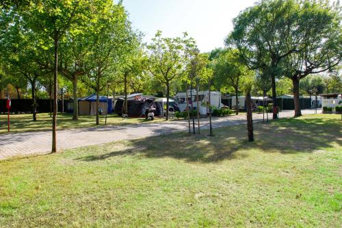 a group of tents in a park with trees at Camping Klaus in Cavallino-Treporti