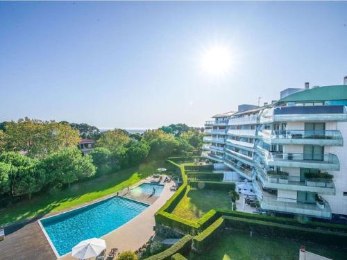a hotel with a swimming pool next to a building at Cascais Lux Apartment 521 letter in Cascais