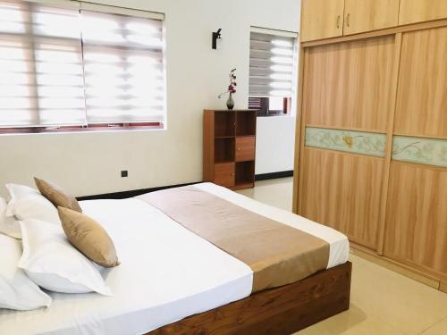 a bedroom with a large bed and a window at Royal Retreat ,Kandy in Kandy
