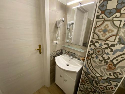 a bathroom with a sink and a mirror at Antico Palazzo Spinola in Gallipoli
