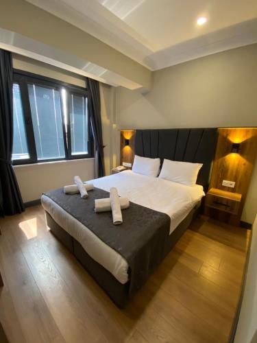 a bedroom with a large bed with two towels on it at Zeyn Otel Istanbul in Istanbul