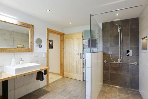 a bathroom with a sink and a shower stall at Beim Lenglacher in Chieming