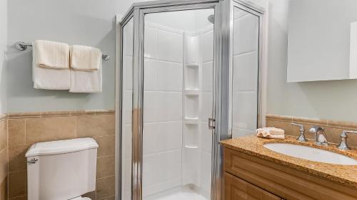 a bathroom with a shower and a toilet and a sink at The Cliffside Resort Condominiums in Greenport