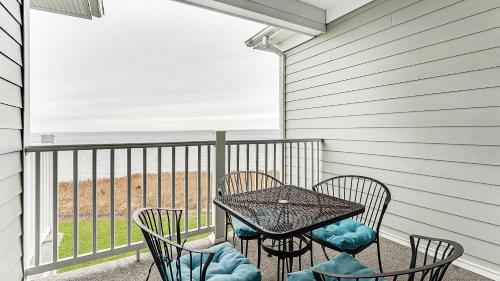 a patio with a table and chairs on a balcony at The Cliffside Resort Condominiums in Greenport