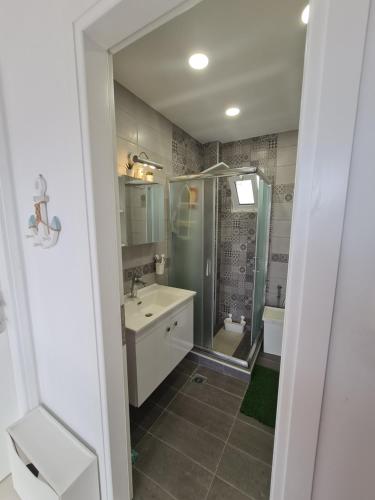 a bathroom with a shower and a sink at Private 24sqm Studio in Lambi, Kos in Kos