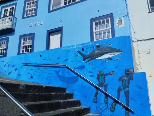 a mural of a shark on the side of a building at SEASTAR nº38 in Horta