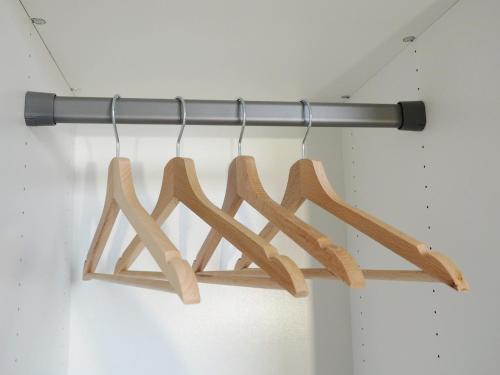 a group of wooden hangers hanging from a rack at Irisapart A65 in Warsaw