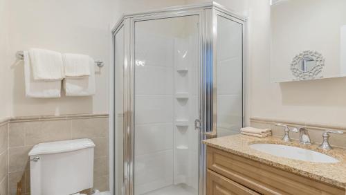 a bathroom with a shower and a toilet and a sink at The Cliffside Resort Condominiums in Greenport