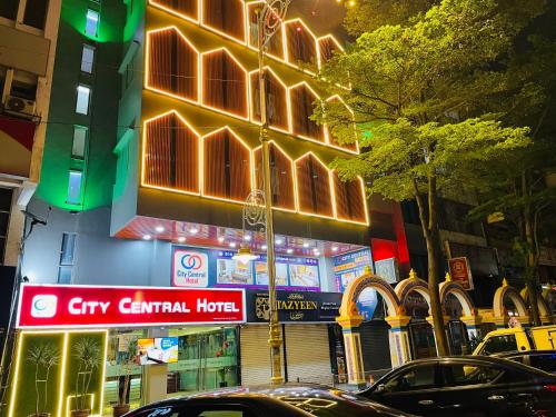 a city street with cars parked in front of a building at City Central Hotel in Kuala Lumpur