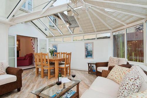 a living room with a couch and a table at Kissing Gate Cottage in Ebrington