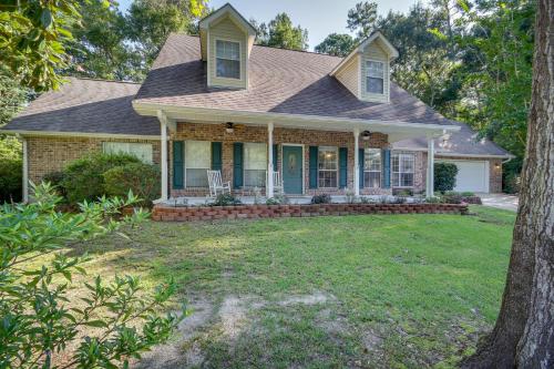 a house with a porch and a yard at Charming Diamondhead Home with Private Yard! in Diamondhead