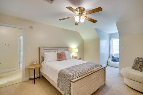 a bedroom with a bed and a ceiling fan at Charming Diamondhead Home with Private Yard! in Diamondhead