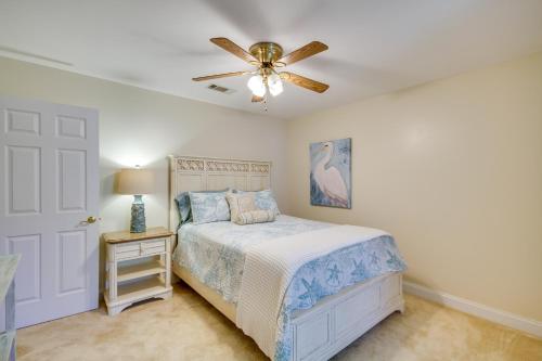 a bedroom with a bed and a ceiling fan at Charming Diamondhead Home with Private Yard! in Diamondhead