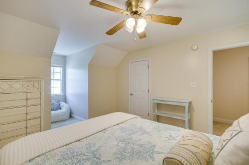 a bedroom with a bed and a ceiling fan at Charming Diamondhead Home with Private Yard! in Diamondhead