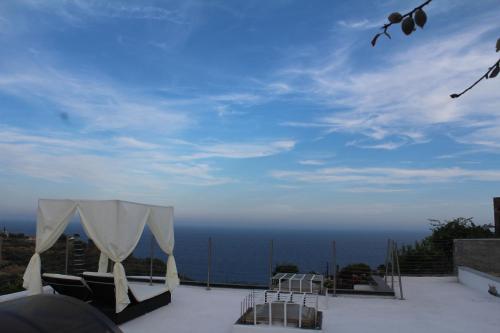 a view of the ocean from a patio with a tent at Villa CliCla - Pool, sea,hommock swing and laziness in Imperia