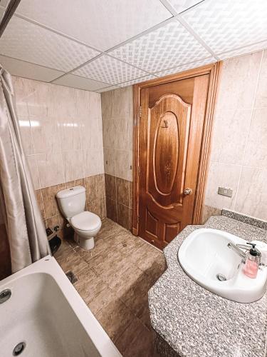 a bathroom with a toilet and a sink and a tub at Serenity Lodge in Sharm El Sheikh