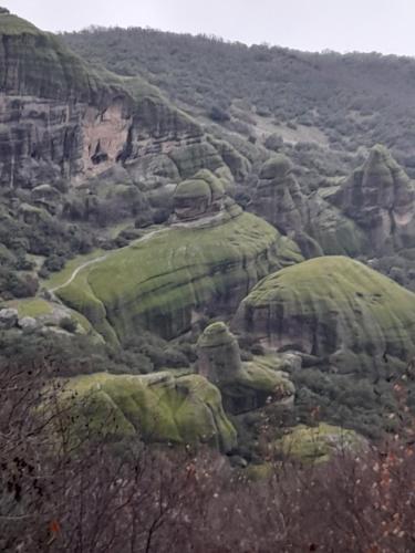 a view of a mountain with green rocks and trees at Villa of byron in Kastrákion