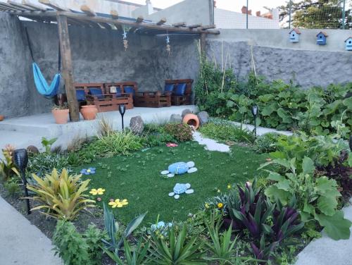 a garden with a miniature yard with chairs and flowers at SEASTAR nº36 in Horta