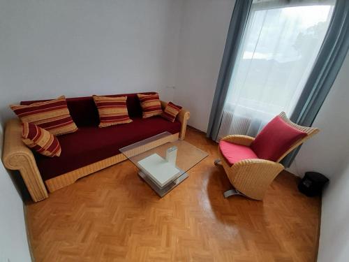 a living room with a couch and a chair at Margarethner Appartments in Sankt Margarethen bei Knittelfeld