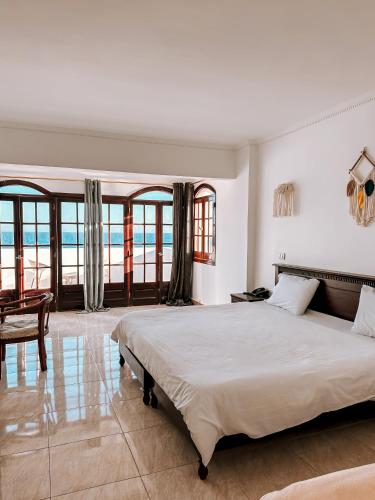 a bedroom with a large bed with a view of the ocean at Serenity Lodge in Sharm El Sheikh
