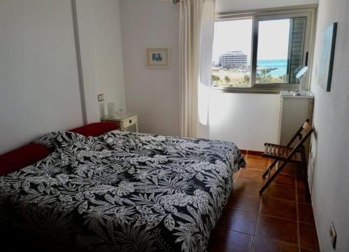 een slaapkamer met een bed en uitzicht op de oceaan bij Seaview Cabezo flat fully equipped with parking in El Médano