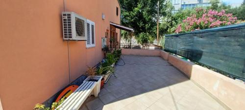 a balcony with a bench on the side of a building at Sunshower apartment and studio in Split
