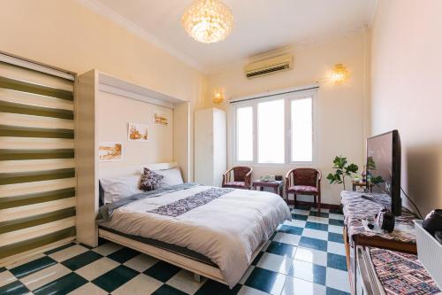 1 dormitorio con 1 cama y TV en una habitación en An Family Homestay, en Hanói