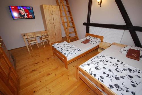 a room with two beds and a table with chairs at Noclegi Dorotowo in Dorotowo
