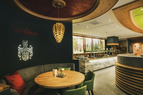 a restaurant with a table and chairs and a counter at Hotel Ochsen in Höfen an der Enz