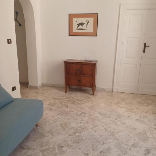 a room with a bed and a table and a door at Don Goffredo in Monopoli
