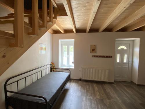 a bedroom with a bed in a room with wooden ceilings at Natural Retreat Shelter #Unoblu® in Agriliá