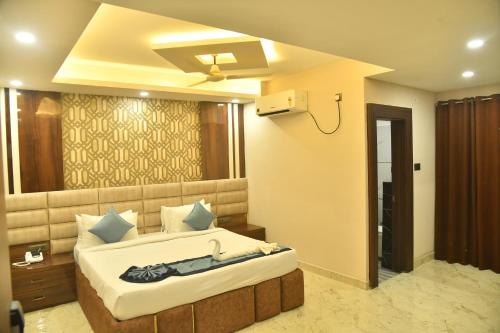 a bedroom with a large bed in a room at City Square in Deoghar