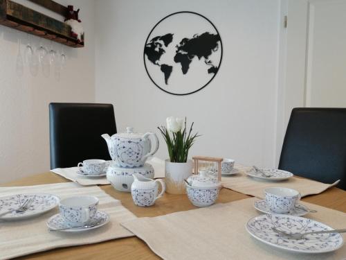 a table with blue and white cups and saucers on it at Kapitänsliebe in Upleward
