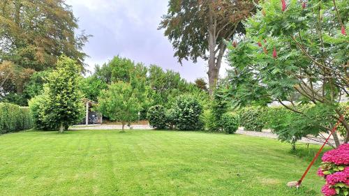 a yard with green grass and trees and bushes at Gîte 3 chambres Au Gré du Vent, Côte d'Albâtre, Normandie in Malleville-les-Grès