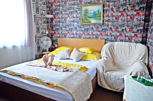 a bedroom with two beds and a wall covered in photos at Jocó Panzió in Nyíregyháza