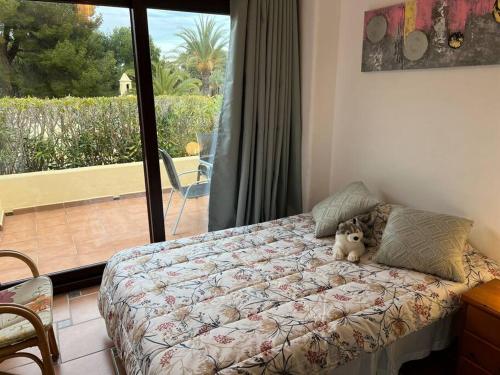 a bedroom with a bed with a teddy bear on it at Entire Bungalow style villa in La Manga Club in Atamaría