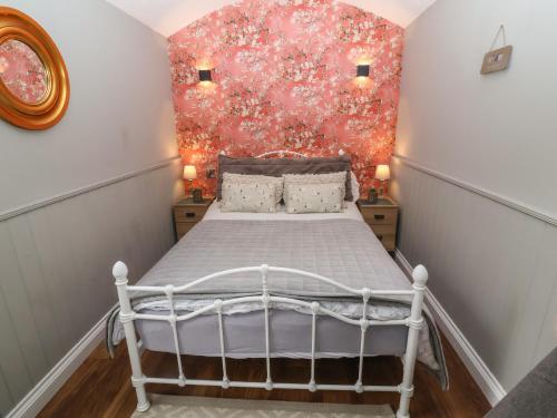 a bedroom with a white bed with a red wall at Whitehedge in York