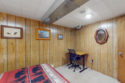 a bedroom with a bed and a desk and a mirror at Hillis House in Arbor Vitae