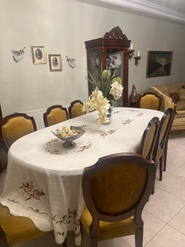 a table with a white table cloth and flowers on it at Kursi in Amman