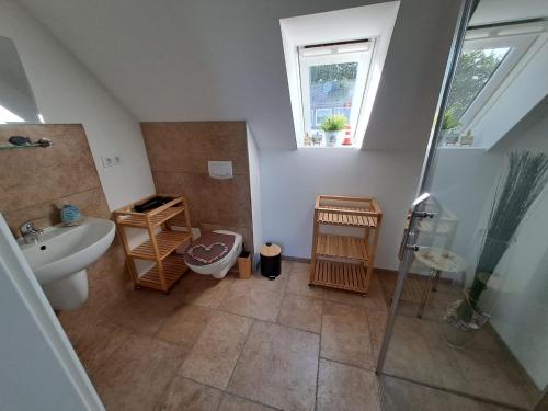 a bathroom with a sink and a shower and a toilet at Ein Stück Glück in Prerow