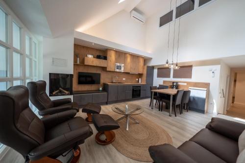 a living room with a couch and a table at Ferienwohnung "Landhaus Buchenallee" in Bad Bentheim