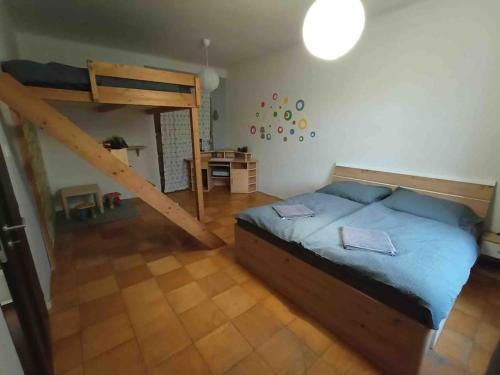 a bedroom with a bunk bed and a ladder at Family MK Apartment in Prague