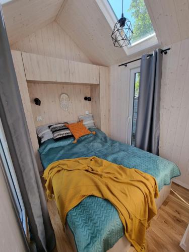 a bedroom with a bed in a small room at Tiny House Jastarnia in Jastarnia