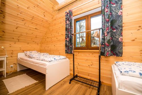 a small room with two beds and a window at Kolorowe Karkonosze in Przesieka