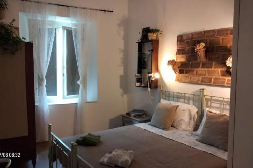 a bedroom with a bed with a brick wall at centro storico di Castelnuovo in Castelnuovo di Garfagnana