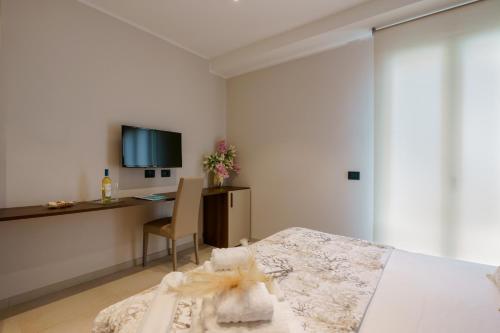 a bedroom with a bed and a desk with a computer at Welcome Cagliari in Cagliari