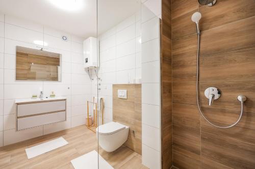 a bathroom with a shower with a toilet and a sink at Beachfront Apartments Tić with Seaview in Miletići