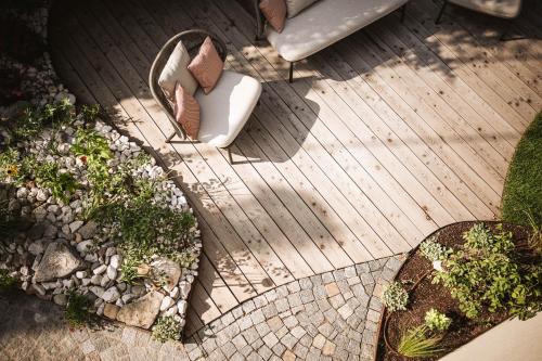 an overhead view of a wooden deck with plants at Milla Apartments in Bressanone