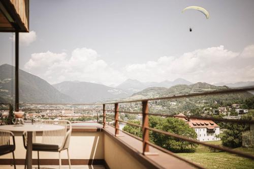 a balcony with a table and chairs and a view at Milla Apartments in Bressanone